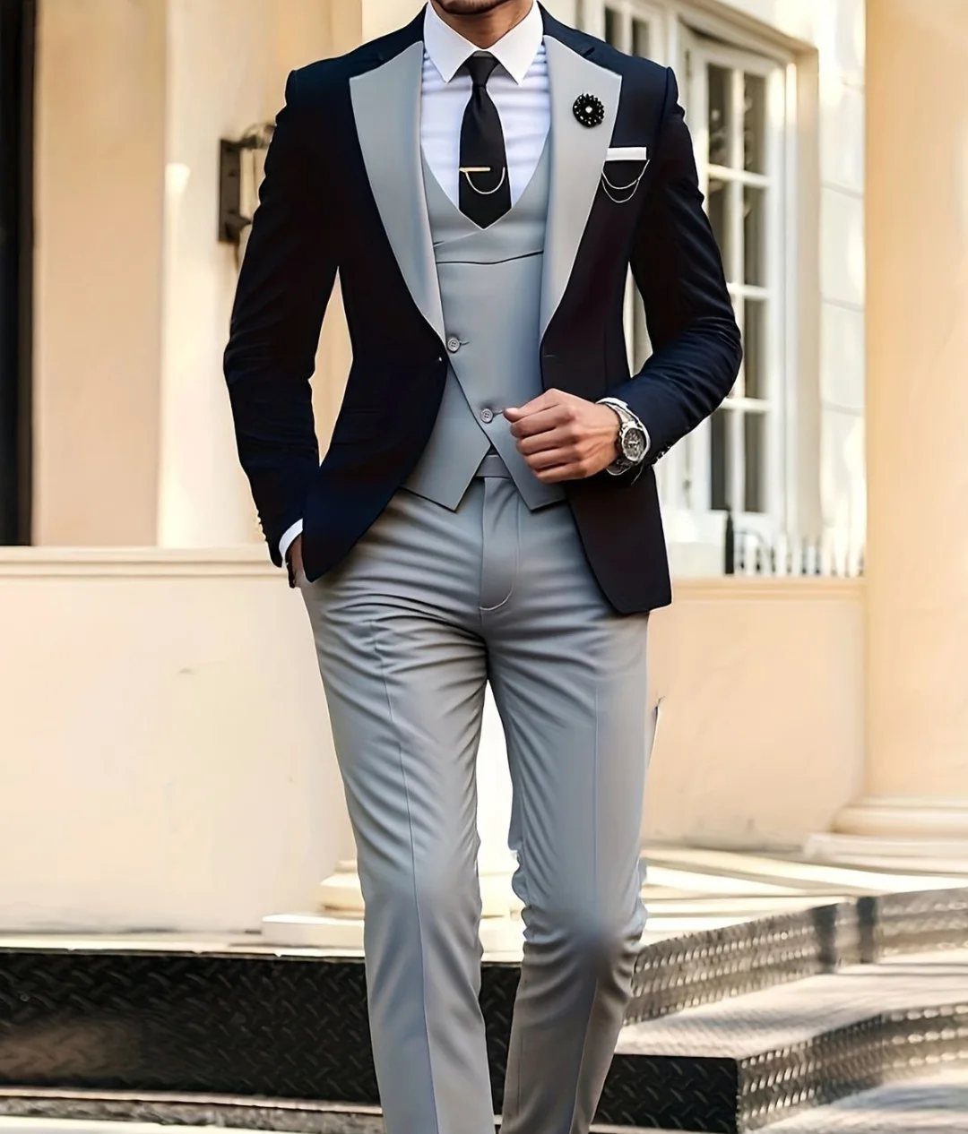 A man dressed in a navy and grey three-piece formal wedding suit standing outdoors.
