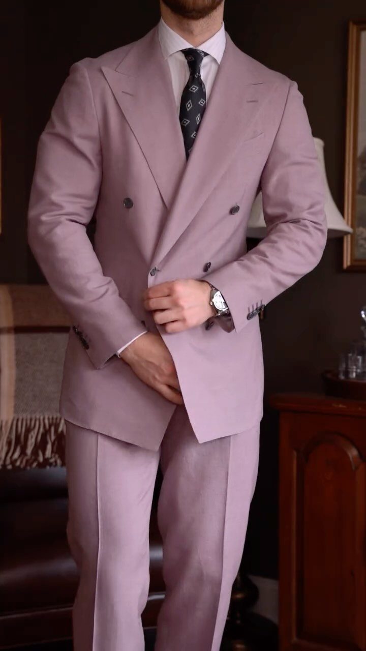 Man wearing a lavender double-breasted suit with a white shirt and dark patterned tie.