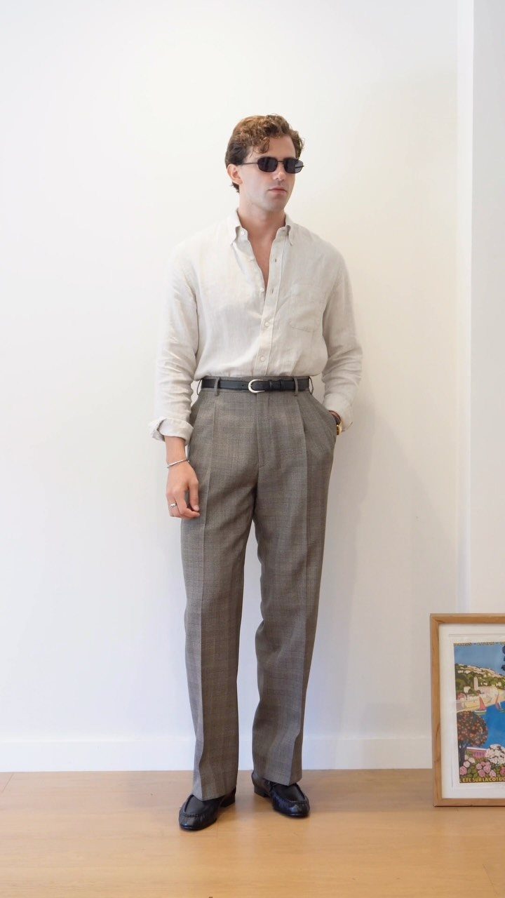 Man in linen shirt and patterned trousers wearing black leather loafers.